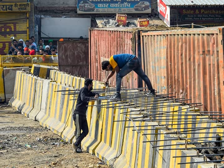 New Delhi: Barricades being set up as part of security enhancements by the police near the site of farmers' ongoing protest against farm reform laws, at Singhu Border, Monday, Feb. 1, 2021. (PTI Photo/Kamal Singh)