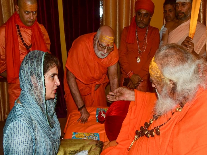 Prayagraj: Congress General Secretary Priyanka Gandhi Vadra meets Jagat Guru Shankaracharya Shri Swami Swaroopanand Ji Maharaj at Mankameshwar Temple, after taking a holy dip at Sangam on the occasion of Mauni Amavasya festival during the ongoing Magh Mela, Thursday, Feb. 11, 2021. (PTI Photo)