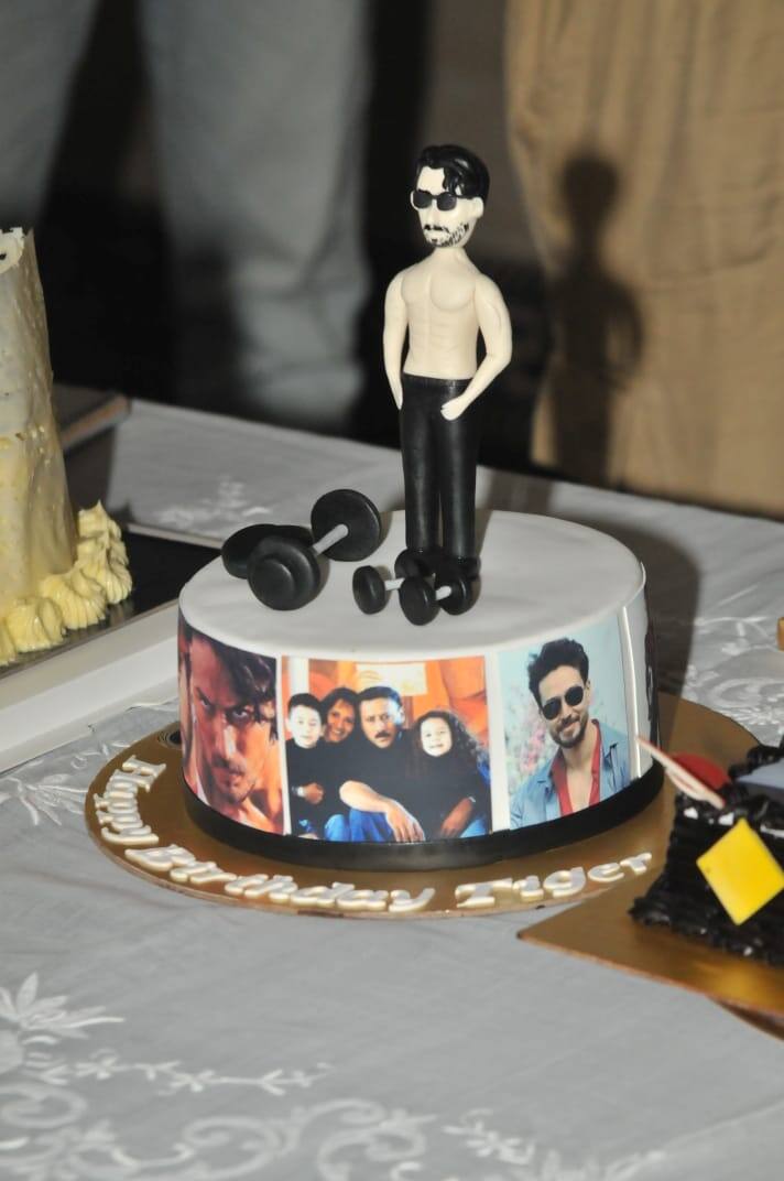 But what caught our attention was the customized cake of the 'Baaghi 2' actor. The cake has a miniature of Tiger along with dumbbells and some rare pictures of him with his closed ones. (Image courtesy - Manav Manglani)