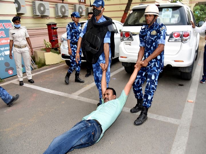 Security personnel remove a Grand alliance legislator who was staging a dharna outside Speaker Vijay Kumar Singhs chamber during Budget Session of Bihar assembly, in Patna. (PTI Photo)