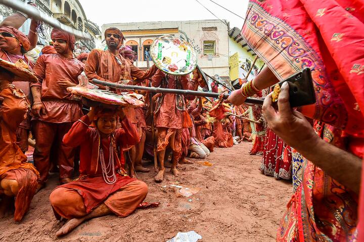 Celebrated a few days before Holi, Lathamar means playing with sticks. In the festival, menfolk try to smear women with colour, who traditionally protect themselves with lathis or sticks. (Image: PTI)