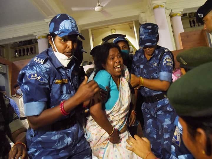 Security personnel remove a Grand Alliance legislator during Budget Session of Bihar assembly, in Patna, Tuesday, March 23, 2021. (PTI Photo)