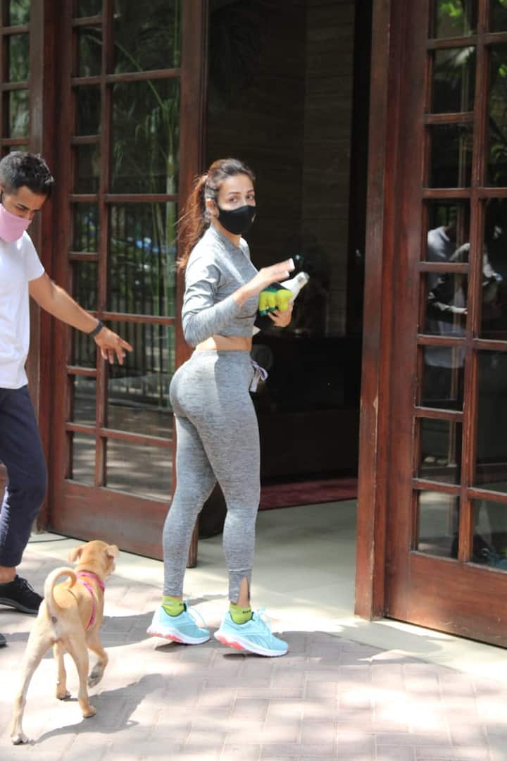 On her way, Malaika was seen petting her cute building puppy. [pic credit: Manav Manglani]