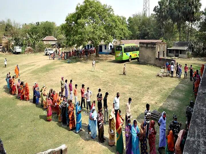বাংলার লালগড়ের চন্দ্রপুরে দেখা যাচ্ছে একটি ভোটকেন্দ্রের বাইরে পুরুষ ও মহিলা ভোটাররা আলাদা আলাদা ভাবে লাইন করে দাঁড়িয়ে আছে। (পিটিআই ছবি)