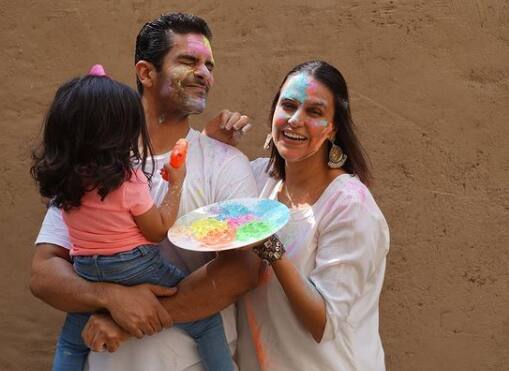 Mehr Dhupia- Neha Dhupia daughter Mehr celebrated Holi with her parents in an adorable manner. The actress shared series of pics from Holi celebration.[pic credit: Instagram/ Neha Dhupia]
