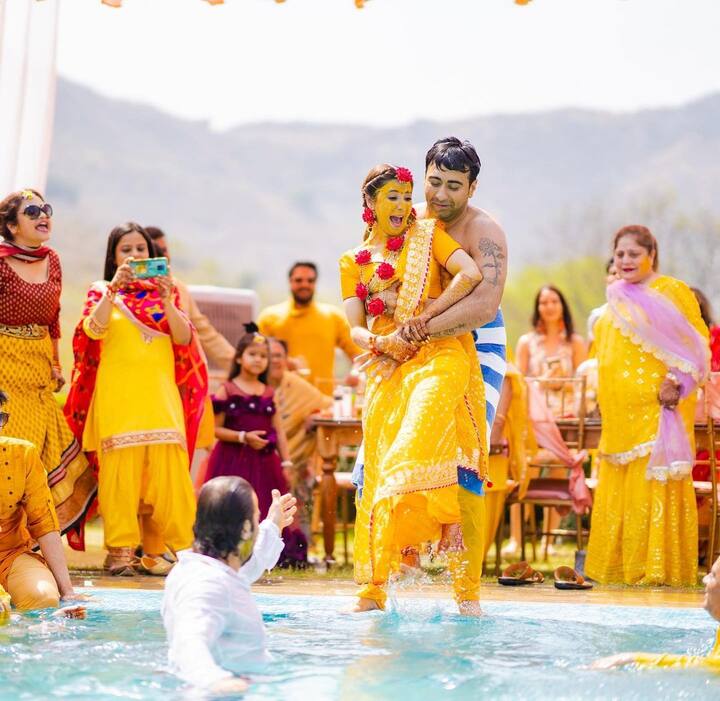 Muskaan looked radiant in a yellow bandhni print saree at her haldi ceremony. Her husband decided to have some fun by throwing her into a pool.