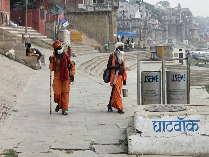 Varanasi: Sadhus seen walking on the banks of river Ganga during weekend lockdown imposed in wake of rising Covid-19 cases across the country, Saturday, April 17, 2021. (PTI Photo)