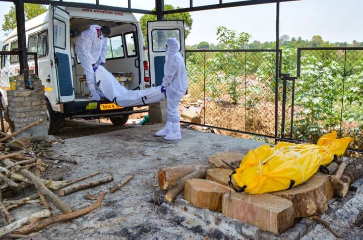 Workers prepare to cremate Covid victims in Karad. Maharashtra recorded 67,013 new cases on Thursday, taking its total tally to over 4 million. From April 15-21, when Maharashtra recorded its highest seven-day average in both cases as well as fatalities, the CFR of Ahmedabad, Nagpur, Mumbai, Nashik, and Pune posed the most concern. (Image: PTI)