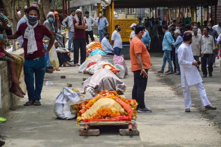 Bodies lined up for cremation at Hindon River base crematorium at Ghaziabad. With an increasing number of deaths in the city, the waiting period in crematoriums has turned into long hours. (Image: PTI)