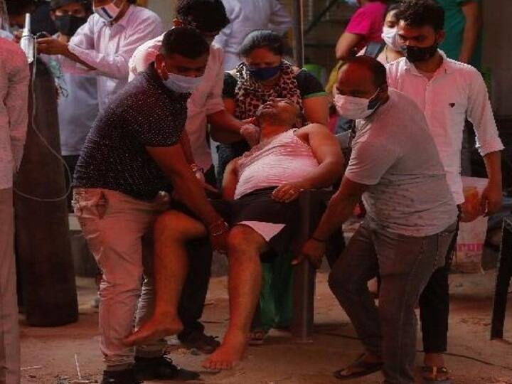 ஆக்சிஜன் உதவிக்காக தூக்கிச்செல்லப்படும் நோயாளி. அடுத்த சில மணி நேரத்தில் அவருக்கு உதவி