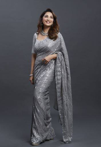 She completes her look with matching neck piece, earrings and a single bracelet on the right hand. The ‘Dhak Dhak’ girl let her hair open and went for matching heels in the photo-op of three images. [pic credit: Instagram/Madhuri Dixit]