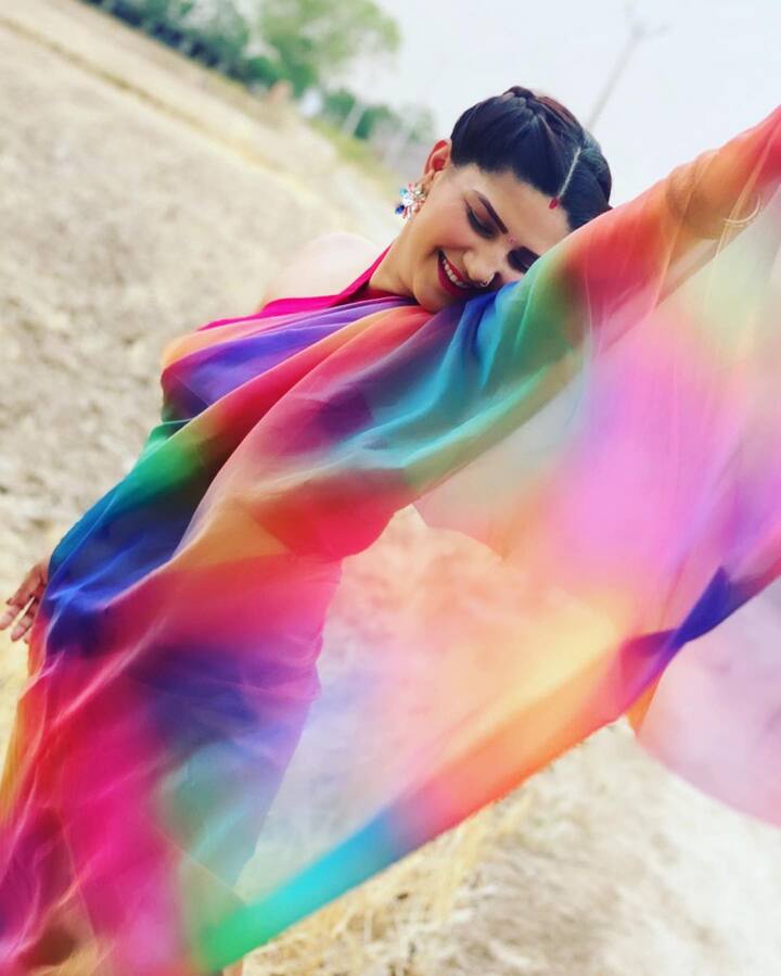 Sapna has shared some of her beautiful photos on social media where she can be seen draped in the six yards of grace. The dancer is wearing a multicoloured rainbow saree which she styled with a sexy backless blouse. (Image courtesy - @itssapnachoudhary/Instagram)