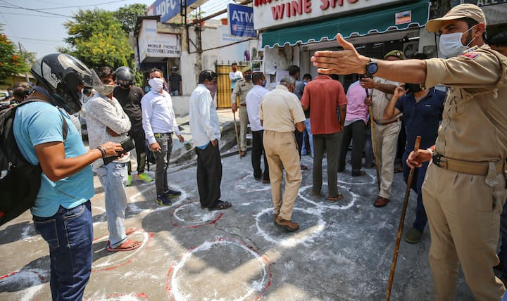 Jammu: Customers wait outside a liquor shop that opened after a month of COVID-induced lockdown. (Image: PTI)