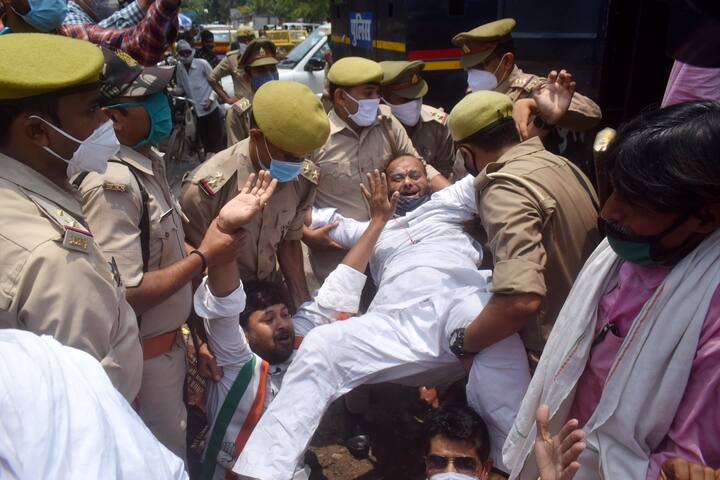 Prayagraj: Police person attempt to detain a Congress activist during their symbolic protest against frequent hikes in the prices of petrol and diesel, in front of a fuel station in Prayagraj. (Image: PTI)