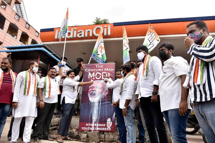 Hyderabad: Youth Congress activists pour milk on a hoarding that says The Century Man PM Modi, during their protest against the price hike of petrol, diesel and LPG, at Amberpet fuel station in Hyderabad. (Image: PTI)