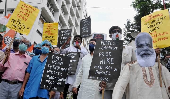 The petrol prices have breached the Rs100-per-litre mark in Rajasthan, Madhya Pradesh, Maharashtra, Andhra Pradesh, Telangana and Ladakh. In the wake of incessant fuel hike and cooking gas prices, the Congress organised symbolic protests in front of petrol pumps across the country on Friday to demand rollback in prices. (Image: PTI)