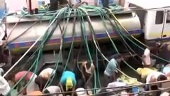 Delhi: People violate social distancing norms while filling water from tanker