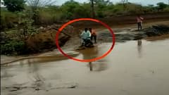 Man on bike swept away in floodwaters, saved by the locals