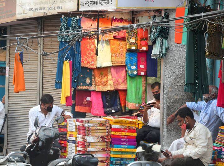 People stand in a queue outside Chandni Chowk outside the metro station after relaxations were announced in Old Delhi. The national capital has been witnessing huge rush outisde grocery shopes and markets after the relaxations were effective from Monday. (Image: PTI)