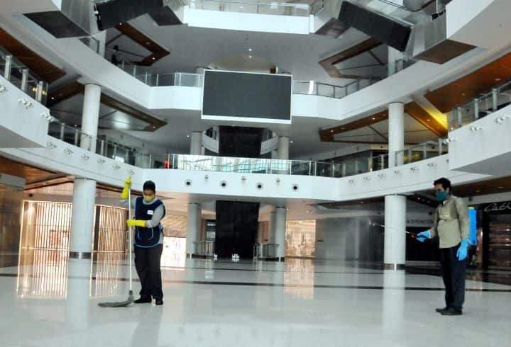 Workers clean and sanitise South City Mall ahead of its reopening with certain restrictions in Kolkata. The West Bengal government extended the lockdown in the state by two weeks, till June 30. Retail shops selling daily needs and bazaars and 'haats' are now allowed to operate from 7 am to 11 am. Other shops can open from 11 am to 6 pm, as can shops in malls where there is a 25 per cent limit on staff strength. Only 30 per cent customers will be allowed inside a mall at a time. (Image: PTI)
