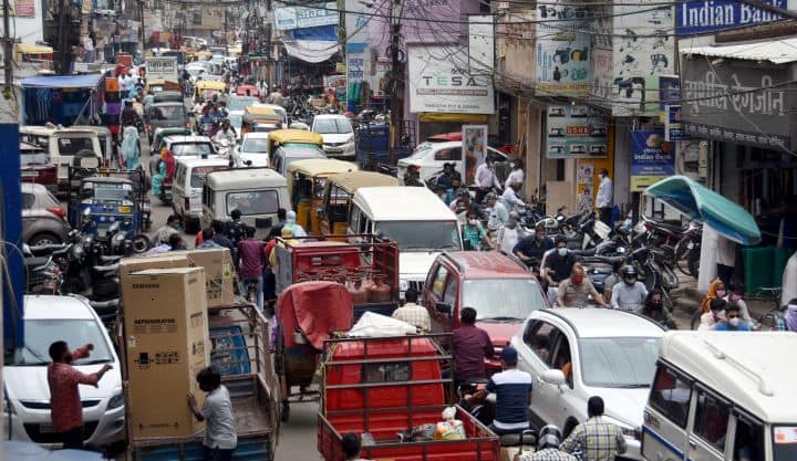 Heavy traffic at Karamchand market after authorities announced relaxations in Covid induced lockdown in Jabalpur. The Madhya Pradesh government on Sunday announced certain relaxations in Covid-19 restrictions amid a decline in coronavirus cases. The state government has now doubled the attendance limit for marriage functions. (Image: PTI)