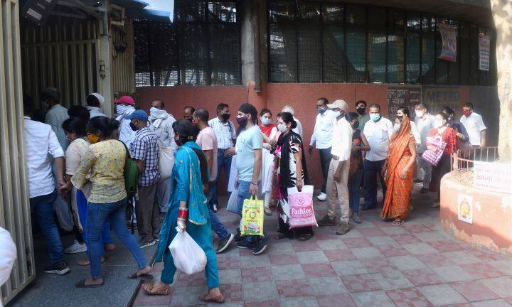 People stand in a queue outside Chandni Chowk outside the metro station after relaxations were announced in Old Delhi. The national capital has been witnessing huge rush outisde grocery shopes and markets after the relaxations were effective from Monday. (Image: PTI)
