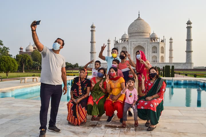 Agra: A man takes a selfie with his family at Taj Mahal that reopened after authorities eased some restrictions in the ongoing Covid-19 lockdown, in Agra. (Image: PTI)