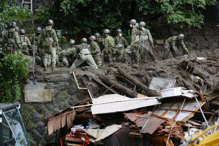 The landslides were triggered by torrential downpours - with some areas receiving more rain in 24 hours than they would usually get for the whole of July. In the photo, Members of Japanese Self-Defence Forces conduct rescue and search operation at a mudslide site caused by heavy rain at Izusan district in Atami. (Image Source: Reuters)