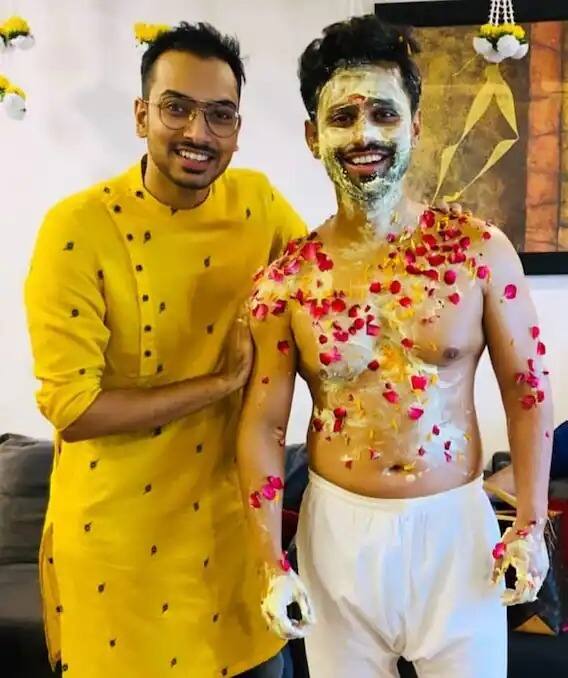 Rahul Vaidya's family members showered him with tumeric and rose petals during the pre-wedding function. He can be seen smiling while posing for the camera.