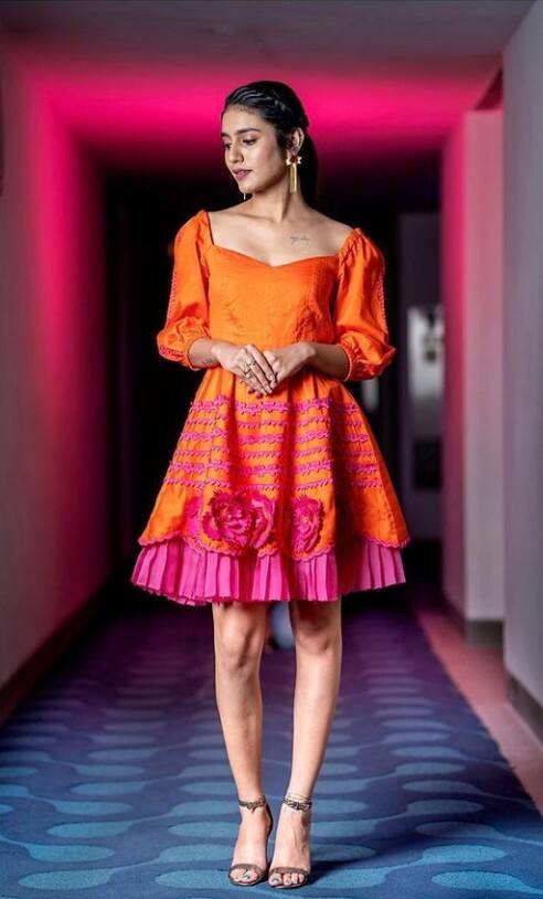 Priya who will be next in Telugu film 'Ishq - Not A Love Story', looks retro chick in this bright orange-pink dress.