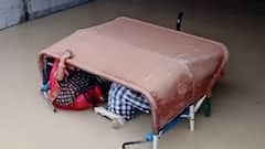 Submerged tractor passes through a water-logged underpass in UP
