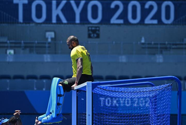 India's goalkeeper Sreejesh Parattu Raveendran celebrates by sitting on top of the goal's crossbar after winning the men's bronze medal match of the Tokyo 2020 Olympic Games field hockey competition by defeating Germany 5-4, at the Oi Hockey Stadium in Tokyo. (Imge Source: AFP)