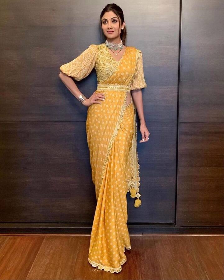 किसी भी आउटफिट को किस तरह कैरी करना है ये जानना है तो शिल्पा शेट्टी को देख लीजिए. भारतीय परिधान हो या फिर वेस्टर्न आउटफिट शिल्पा शेट्टी हर ड्रेस को इतनी खूबसूरती से कैरी करती हैं कि बस देखते ही रह जाएं. अब इस बांधनी साड़ी को ही ले लीजिए. एक सिंपल साड़ी को किस तरह डिजाइनर बनाया जा सकता है वो आपको शिल्पा की ये तस्वीर देखकर समझ आ गया होगा. शिल्पा ने ब्लाउज़ की स्लीव्स को डिजाइन से बनवाकर और साड़ी को स्टाइलिश अंदाज में कैरी कर इसे स्पेशल बना दिया. (फोटो – सोशल मीडिया)