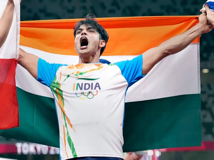 Neeraj Chopra holds the Tricolor after winning gold medal in the final of the mens javelin throw event at the 2020 Summer Olympics, in Tokyo. (PTI Photo/Gurinder Osan)