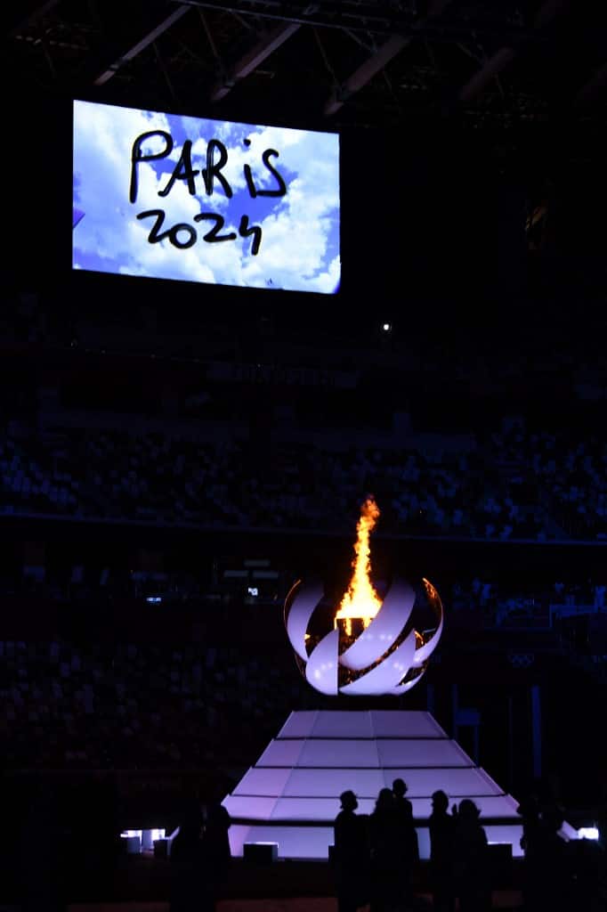 A video announcing the next Olympics Game of Paris 2024 is shown next to the Olympic Cauldron and the Olympic flame during the closing ceremony of the Tokyo 2020 Olympics.  (Image: AFP)