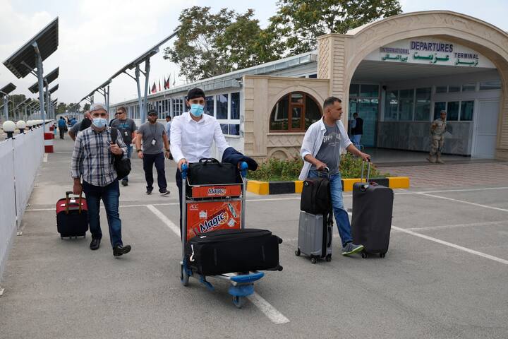 Passengers walk to the departures terminal of Hamid Karzai International Airport in Kabul, Afghanistan. (Image Source: AP Photo)