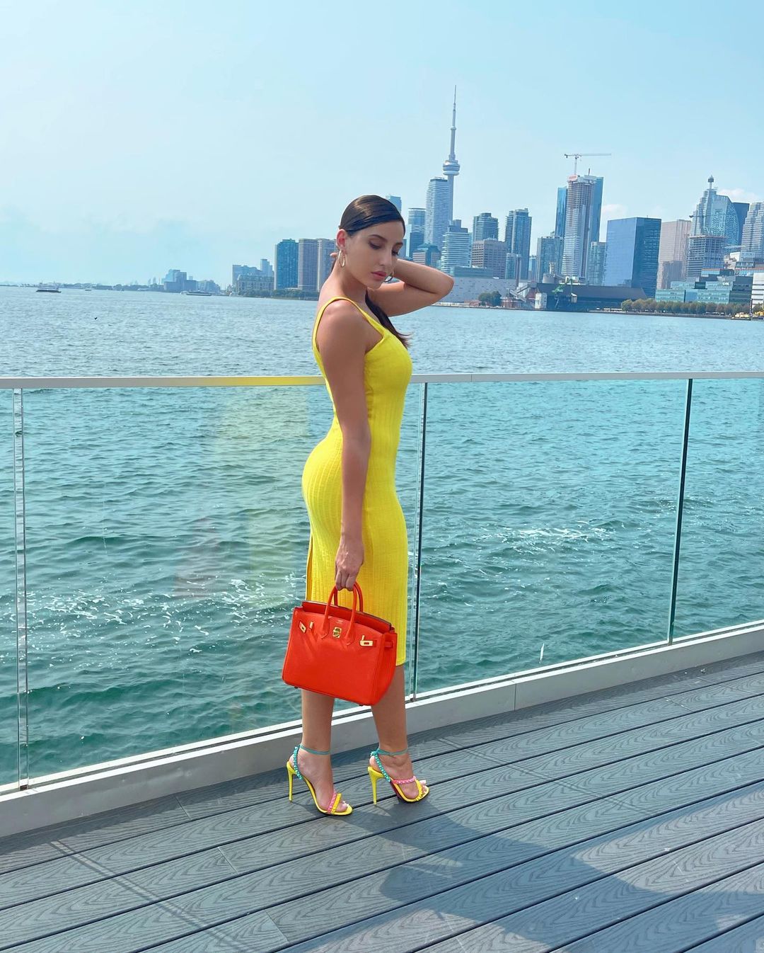 Nora Fatehi pairs sexy neon yellow bodycon dress with ₹3 lakh bag for shoot