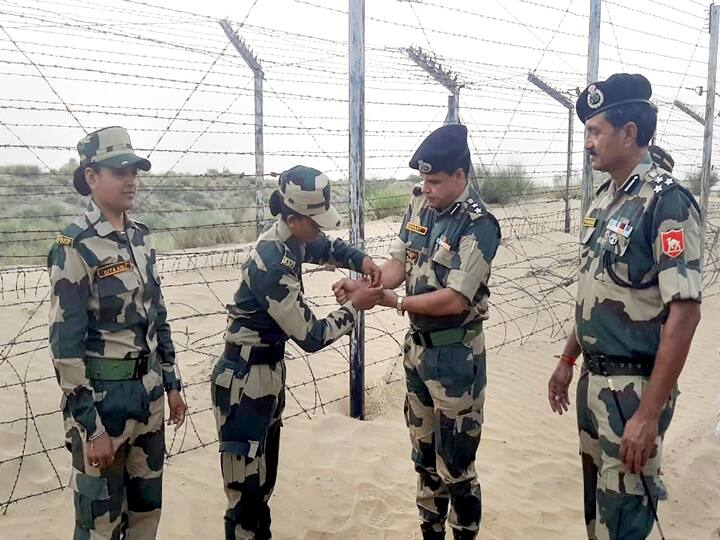 Bikaner: BSF woman constable ties a 'Rakhi' to a BSF officer on the occasion of Raksha Bandhan festival, near Tarbandi on the India-Pakistan International Border, Sunday, Aug. 22, 2021. (PTI Photo)