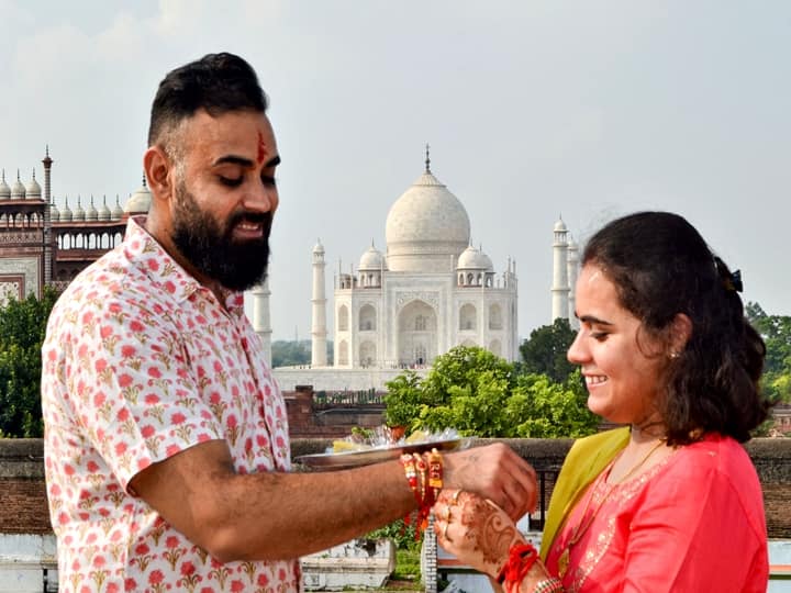 A sister ties 'Rakhi' on her brother's wrist on the ocassion of Raksha Bandhan in Agra, Sunday, Aug. 22, 2021. (PTI Photo)