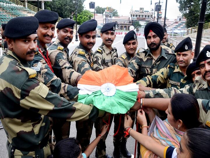 Attari: Women tie tricoloured rakhi on the wrists of Border Security Force (BSF) jawans on the occasion of Raksha Bandhan festival at Attari-Wagha border near, Amritsar, Sunday, Aug. 22, 2021. (PTI Photo)