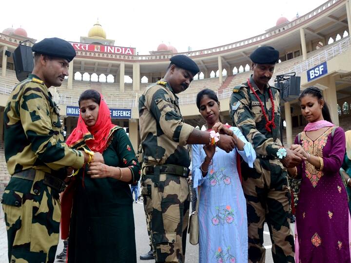 Several women celebrated the occasion of Raksha Bandhan with Border Security Force (BSF) jawans at Attari-Wagha border near Amritsar, Sunday, Aug. 22, 2021. (PTI Photo)