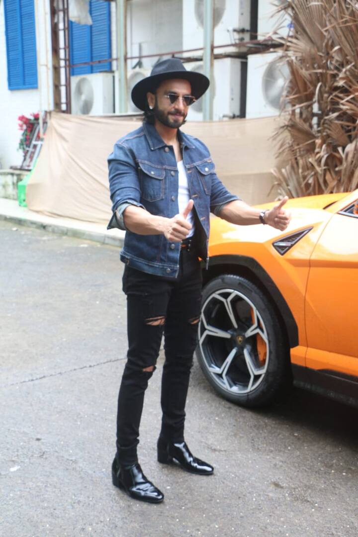 While Padukone can be seen wearing a red top with black trousers, her husband Ranveer can be spotted wearing a denim jacket over white t-shirt. He completed his look by sporting a hat and a funky pair of sunglasses. (Image courtesy – Manav Manglani)