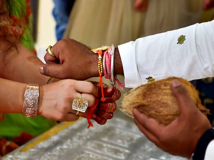 A sister ties a 'Rakhi' to her brother on the occasion of Raksha Bandhan festival in Bengaluru, Sunday, Aug. 22, 2021. (PTI Photo/Shailendra Bhojak)
