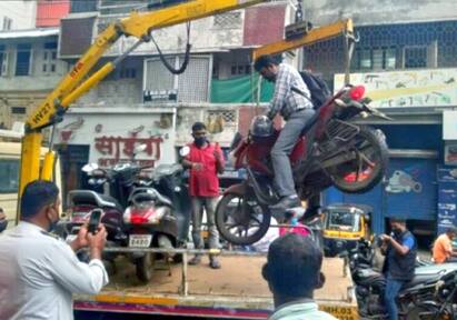 Pune Traffic Police officials tow bike with the owner sitting on it நோ பார்க்கிங்ல பைக்.. ஆளோடு அலேக்காக தூக்கிய போலீசார்.. வலுக்கும் கண்டனம்!