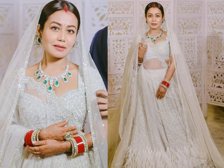 बॉलीवुड सिंगर नेहा कक्कड़ ने पंजाबी गायक रोहनप्रीत के साथ शादी की है. उन्होंने अपने रिसेप्शन में व्हाइट कलर का लहंगा पहना था. इस लुक में वो परी की तरह लग रही थीं. इस लहंगे के साथ उन्होंने डायमंड ज्वैलरी पहनी थी.