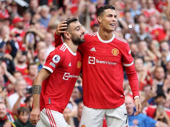 Portuguese Connection: Bruno Fernandes of Manchester United celebrates with Cristiano Ronaldo after scoring their side's third goal during the Premier League match between Manchester United and Newcastle United at Old Trafford. (Getty Images)