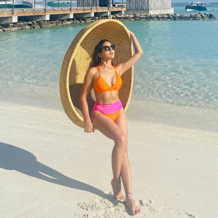 Bollywood actress Sara Ali Khan, who is very active on social media, dropped some breath-taking pictures of herself on Instagram, wearing an orange-pink bikini. The ‘Atrangi Re’ actress can be seen posing by the sea. (Image courtesy - @saraalikhan95/Instagram)