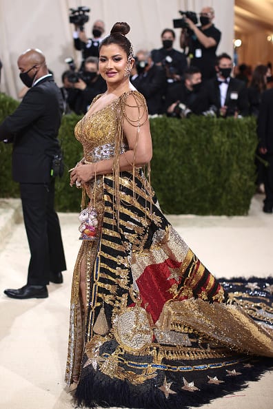 Completing her attire with a pair of sequined gold stilettos from Chanel, Sudha accessorised her look with a glitzy Ganesha clutch. She pulled back her tresses into a top knot to flaunt a pair of Farah Khan Ali's ornate diamond ear cuffs . [pic credit: Gettyimages]