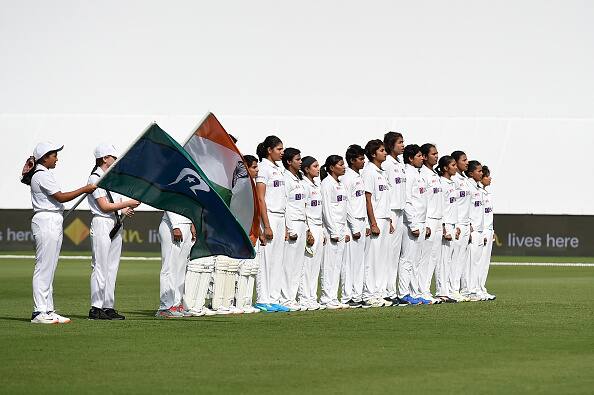 Players of India stand together for the national anthems during day one of the Women's International Test match between Australia and India at Metricon Stadium. This is the first Pink Ball Test for India's women's team. (Getty Images)