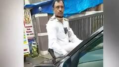 Traffic cop in Mumbai sits on car bonnet to stop vehicle | Watch Video